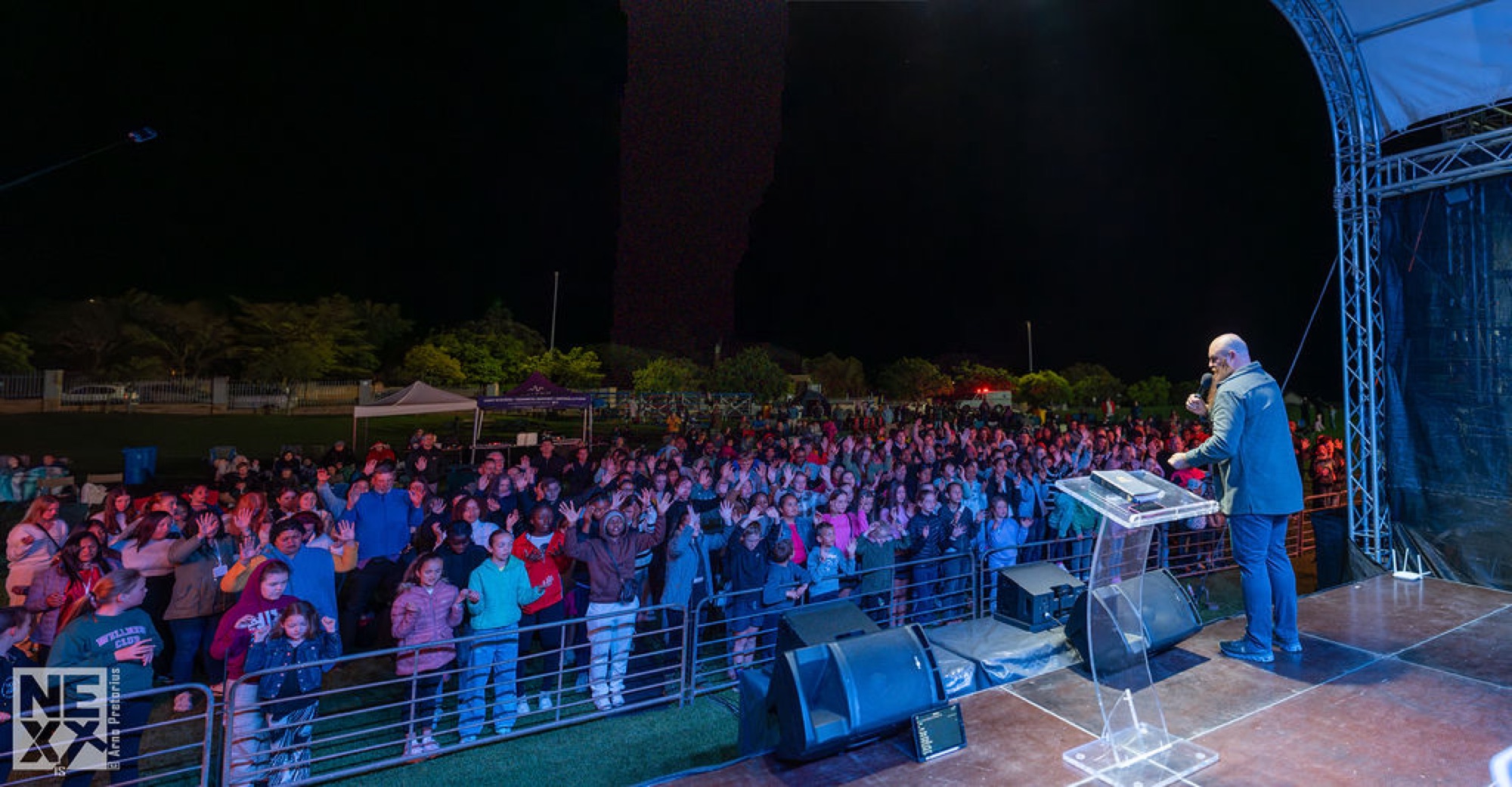 A night crowd gathered under lights